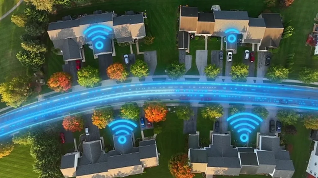 Aerial top-down view of American homes with glowing fiber optic lines and Wi-Fi symbols showing high-speed internet