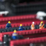 Group,Of,Miniature,Engineers,Fixing,Computer,Circuit,Board.,Macro,Photo